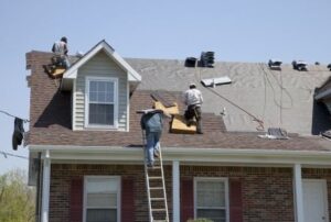Roofers replacing roof on home 